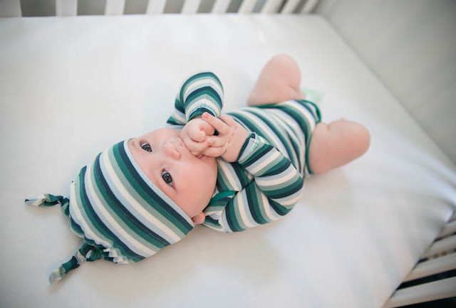 Baby in Crib Green Stripped Onsie