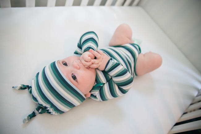 Baby in Crib Green Stripped Onsie